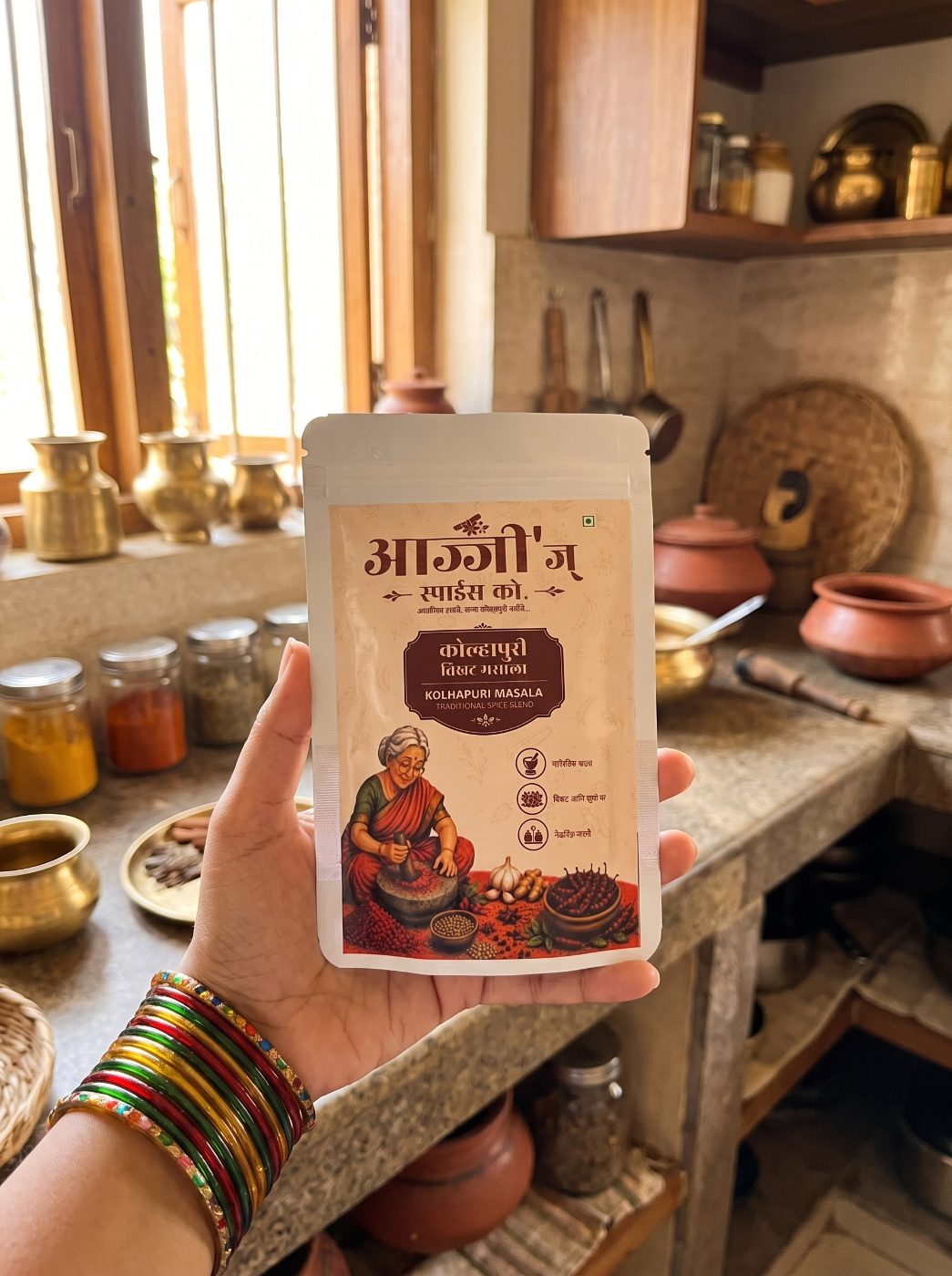 Hand holding Ajji's Kolhapuri Masala pouch